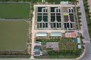 Bird's eye view of a water treatment facility in Hiệp Hòa, Bac Giang, Vietnam showing ponds and infrastructure.